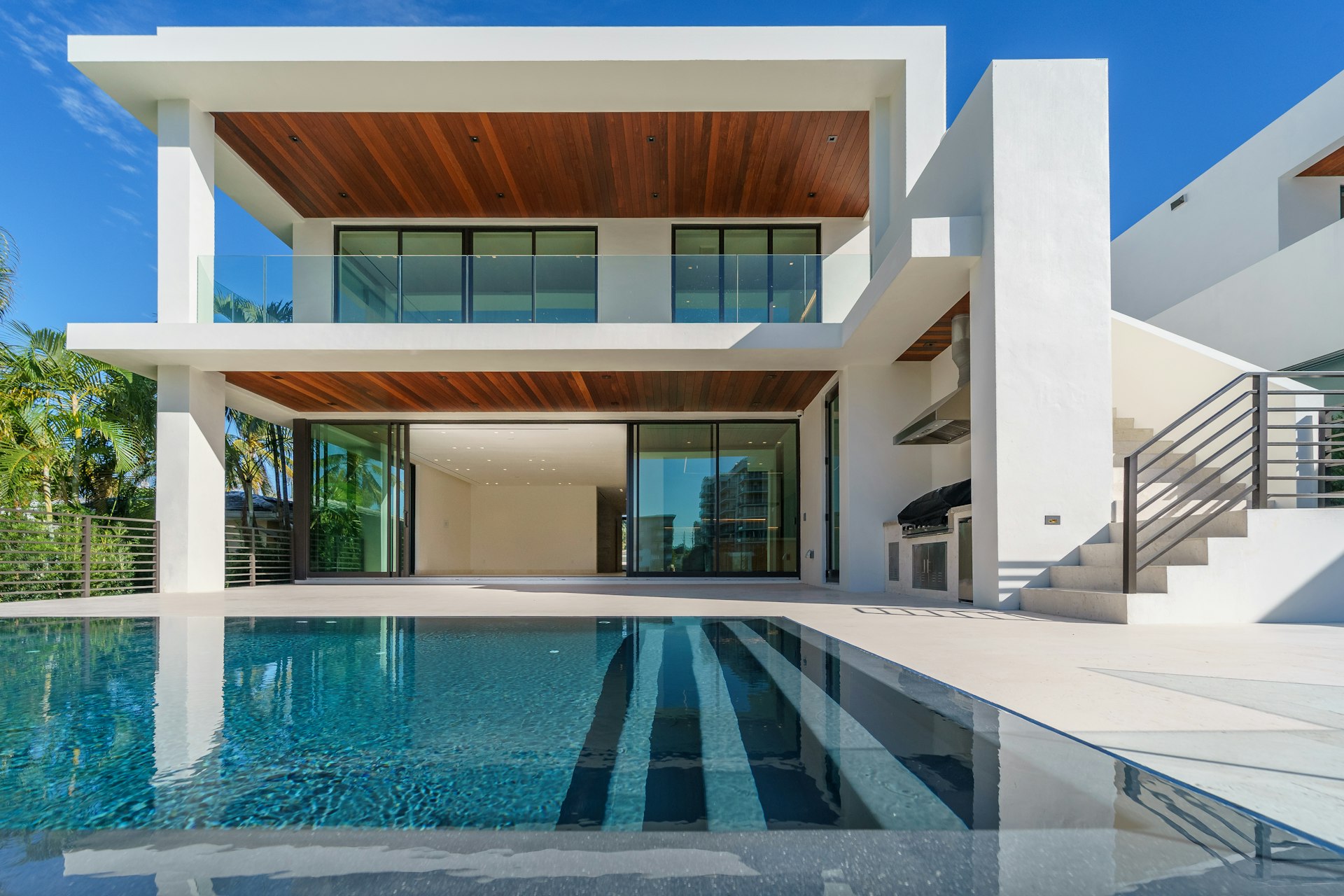 A pristine backyard swimming pool at dusk beside a modern Arizona home